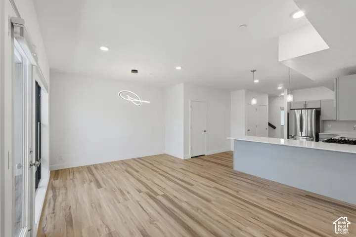 Open-concept living area with wood-finish flooring