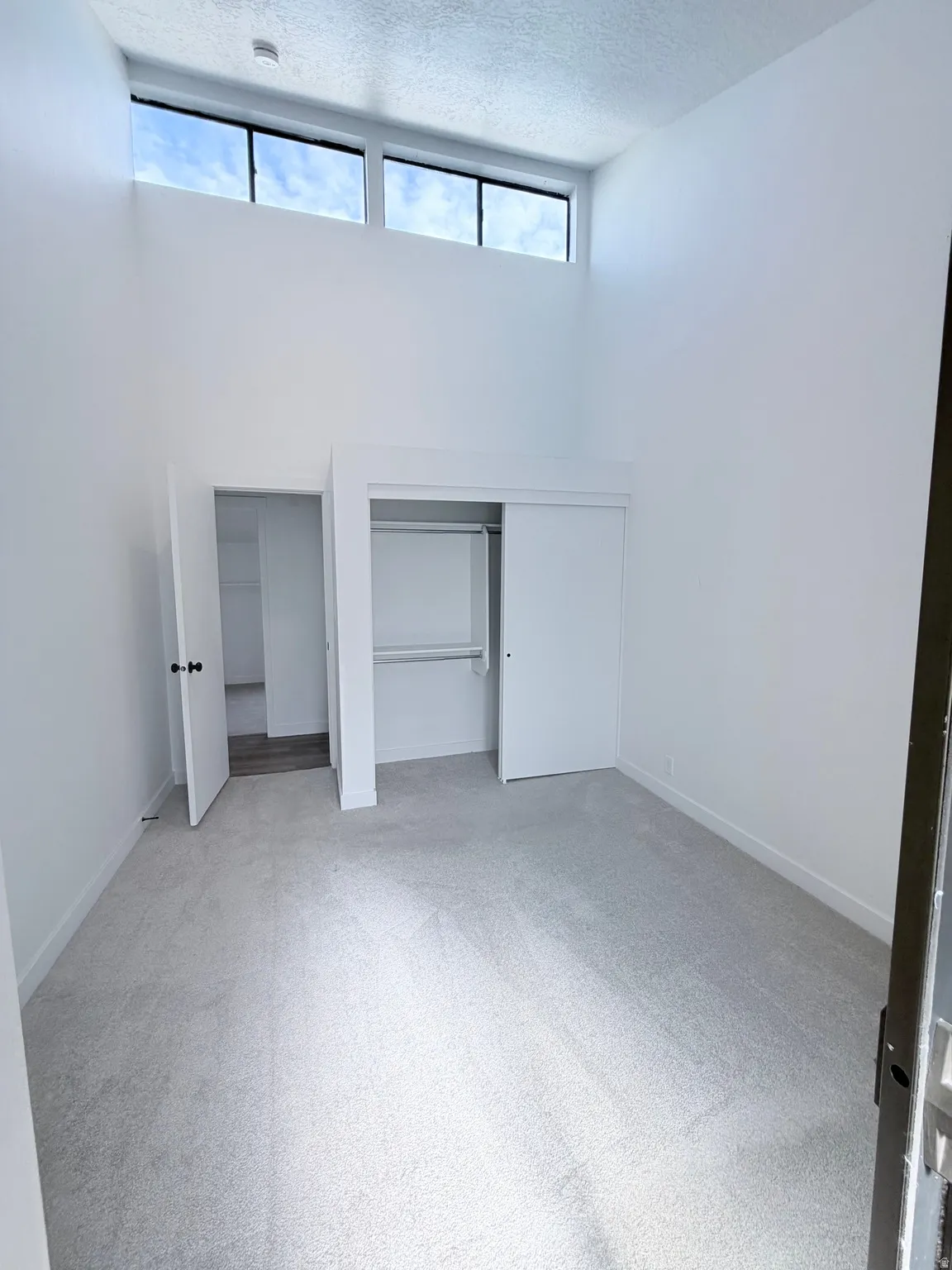 Interior room with vaulted ceilings and high-level windows