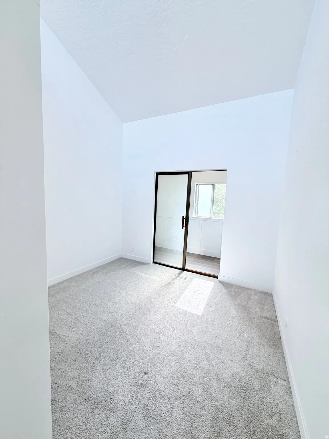 Room featuring light gray carpeting and white walls
