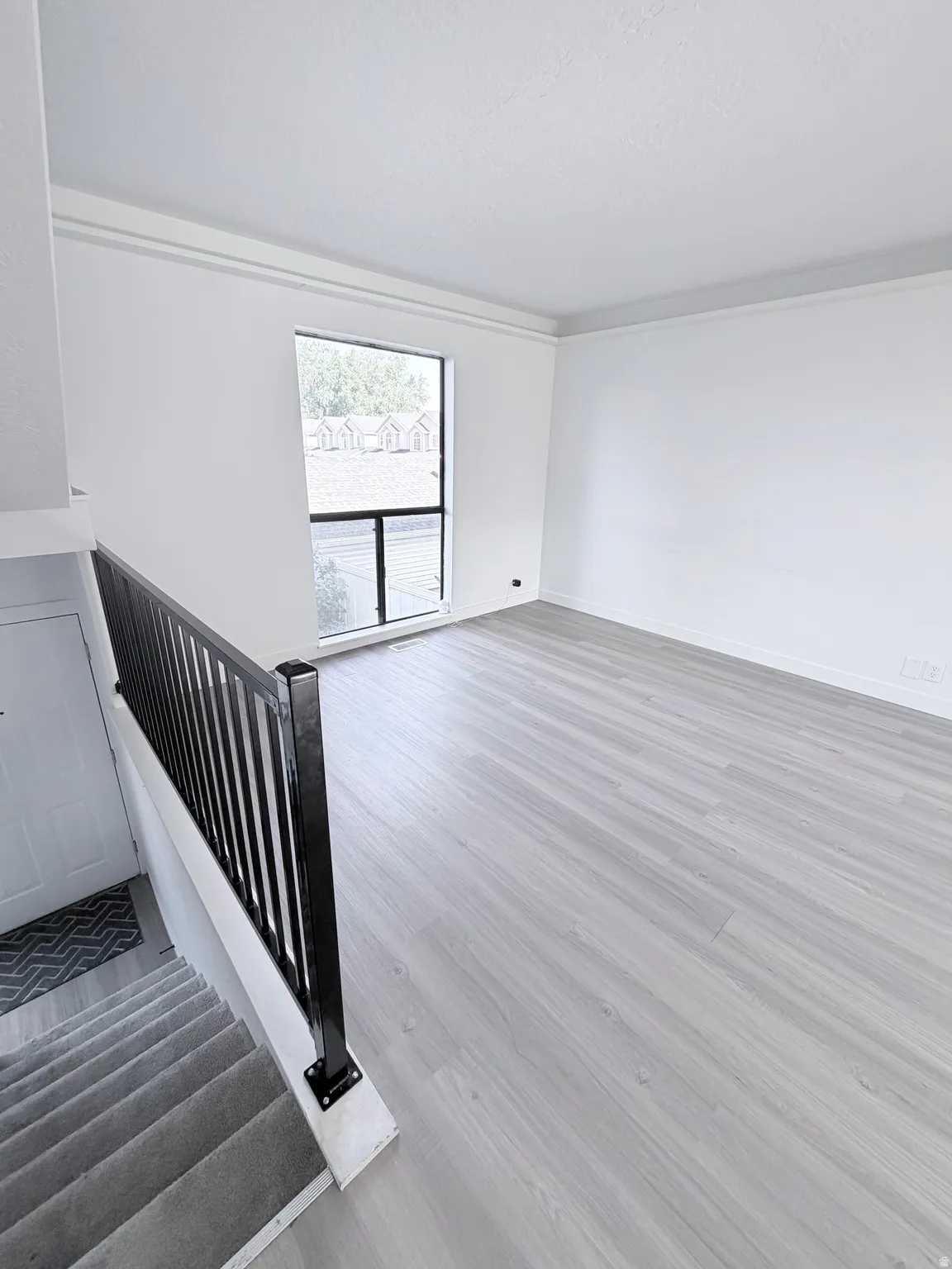 Open concept living area featuring light wood-finish flooring
