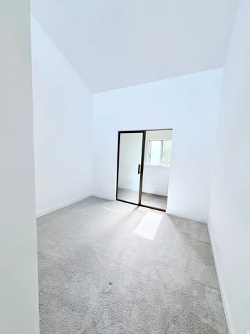 Room featuring light gray carpeting and white walls