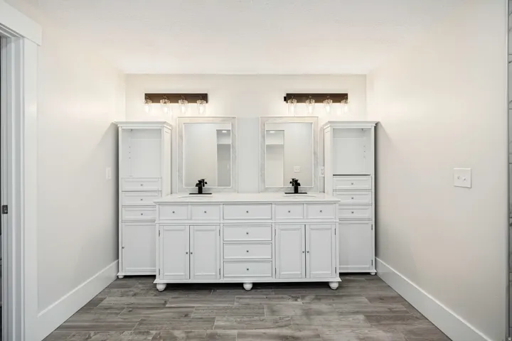 Spacious double vanity with white cabinetry, dual sinks, and matte black fixtures
