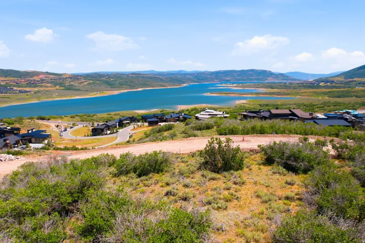 Expansive land parcel featuring natural shrubbery and a clear line of sight to the surrounding mountain range