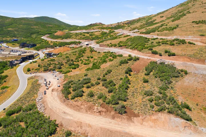 Expansive hillside property featuring natural vegetation and cleared building pads