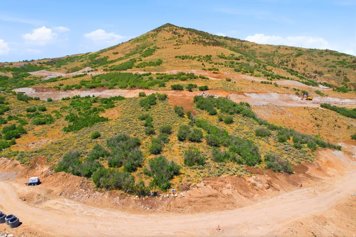 Expansive mountain landscape featuring varied elevations and natural foliage