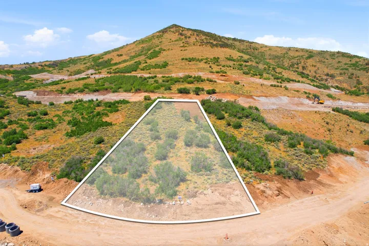 Mountainous terrain featuring natural vegetation and cleared areas