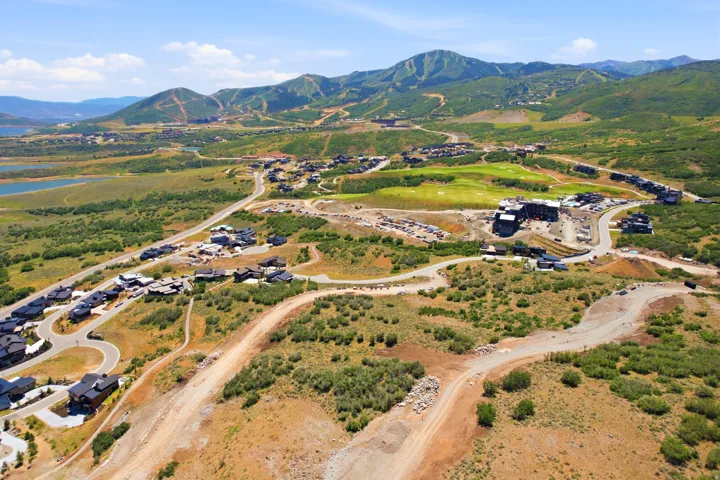 Expansive aerial view showcasing a developing community with multiple residential structures