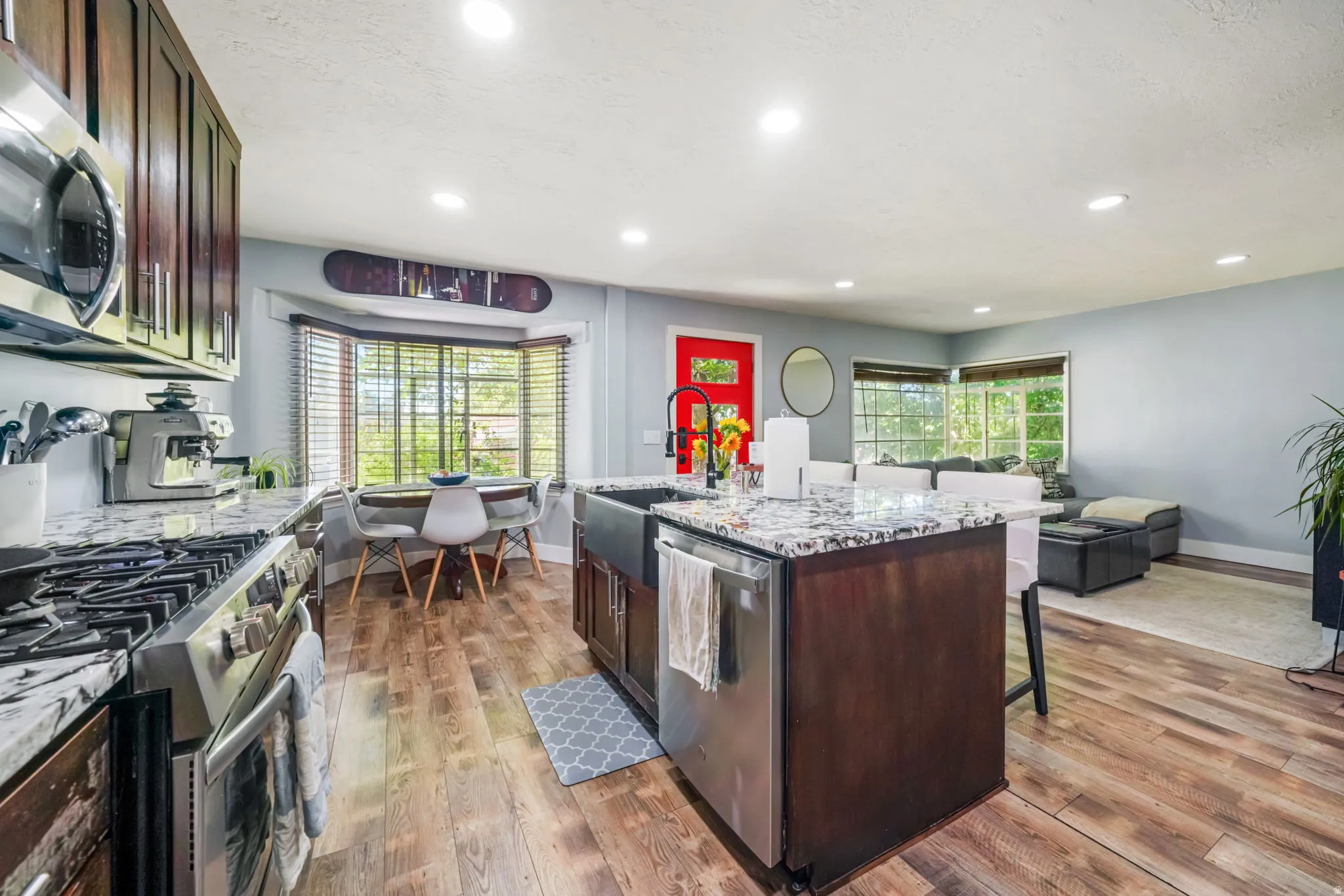 Kitchen island featuring an undermount sink and a stainless steel dishwasher