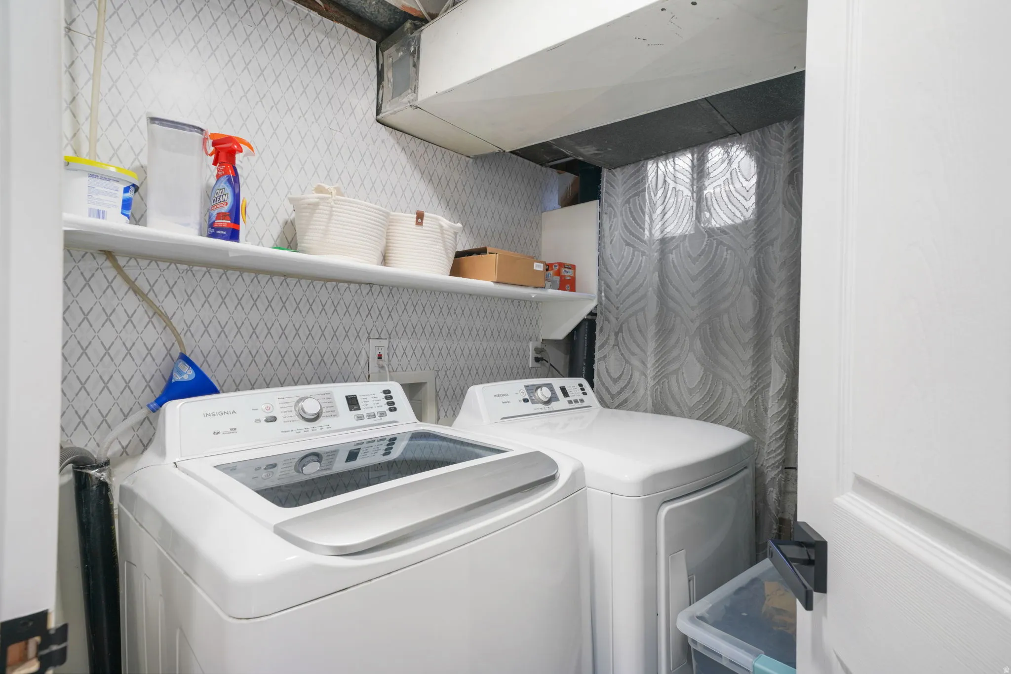 Dedicated laundry area featuring a white top-load washing machine and dryer