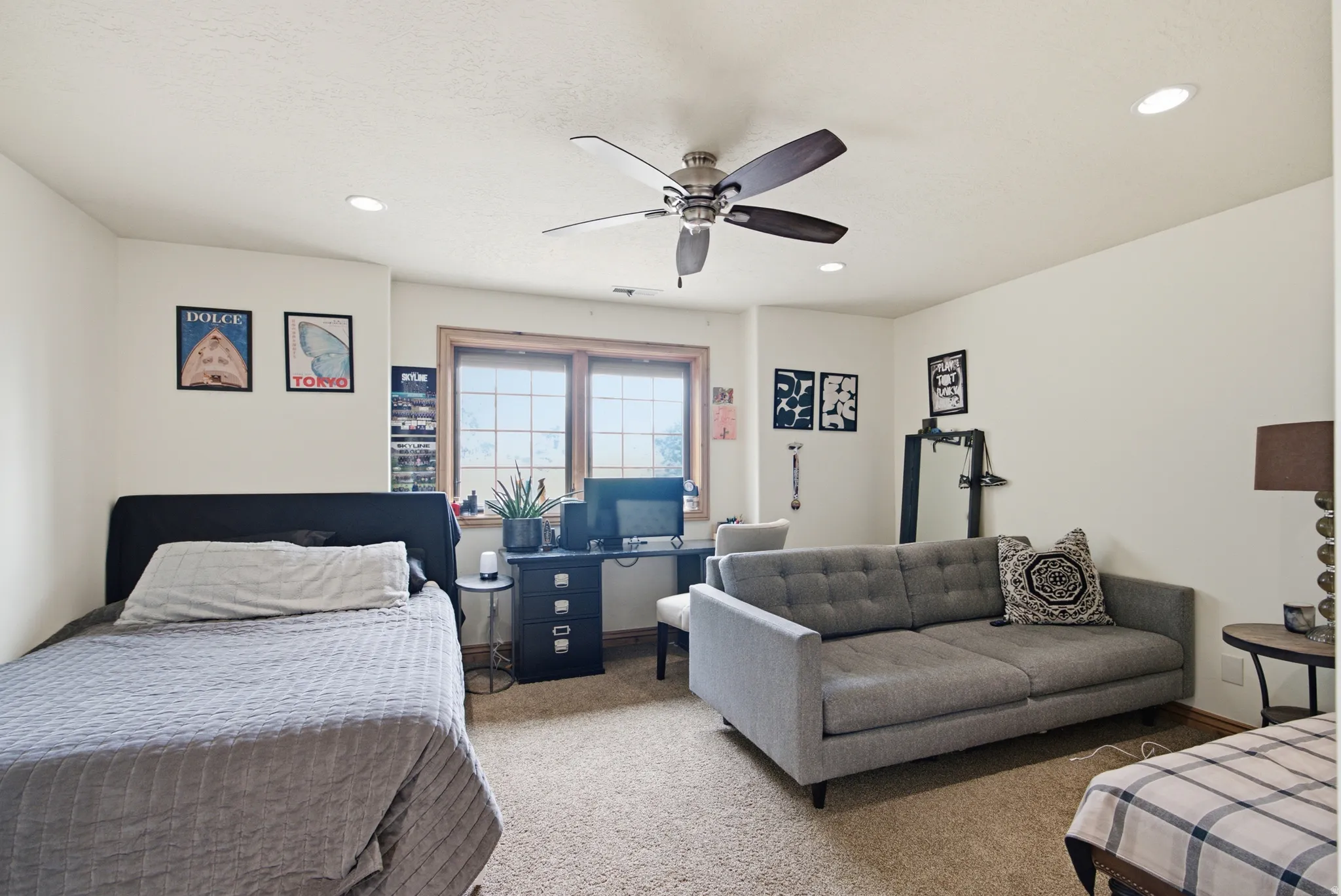 Neutral wall tones with recessed lighting and a ceiling fan