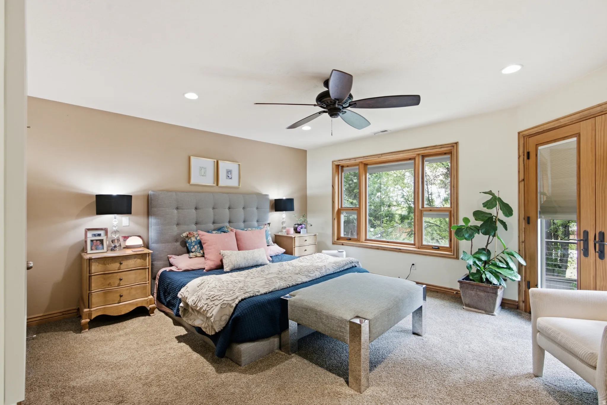 Spacious room featuring a multi-pane window, wood-finish French doors, a ceiling fan with light, recessed lighting, and soft carpet flooring