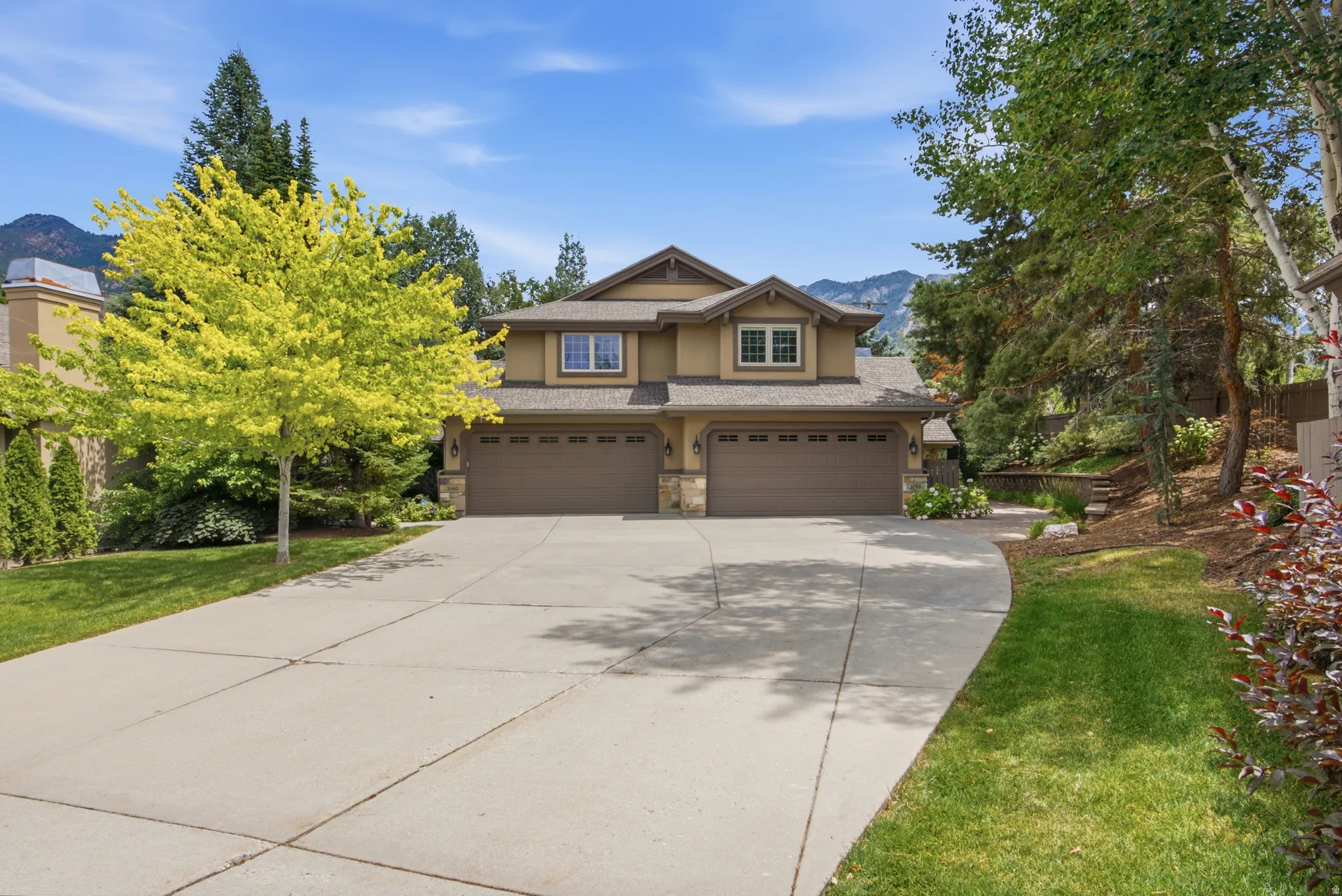 Stucco exterior with stone accents and a multi-car garage
