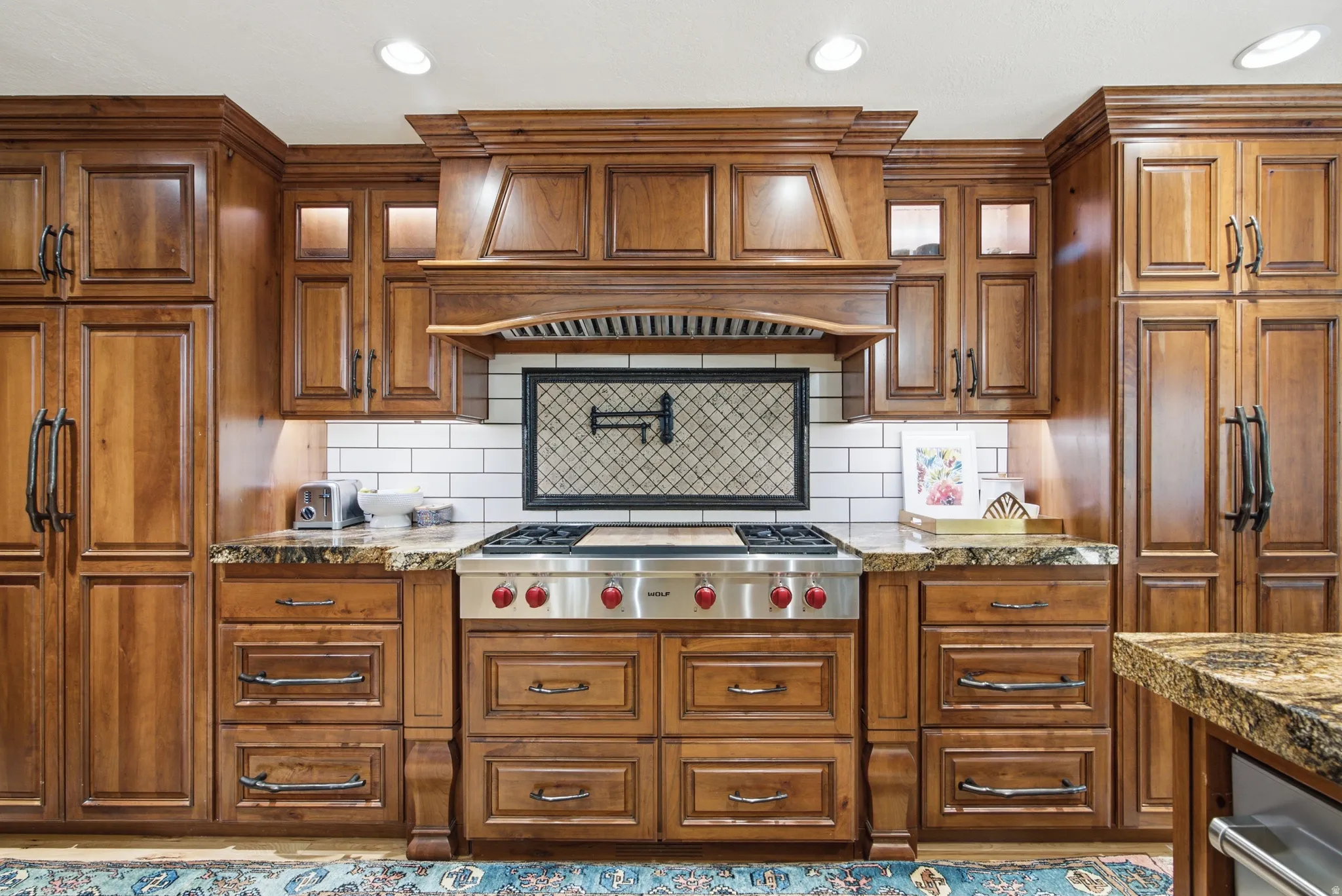Gourmet kitchen with rich wood cabinetry, a professional-grade stainless steel range, and granite countertops