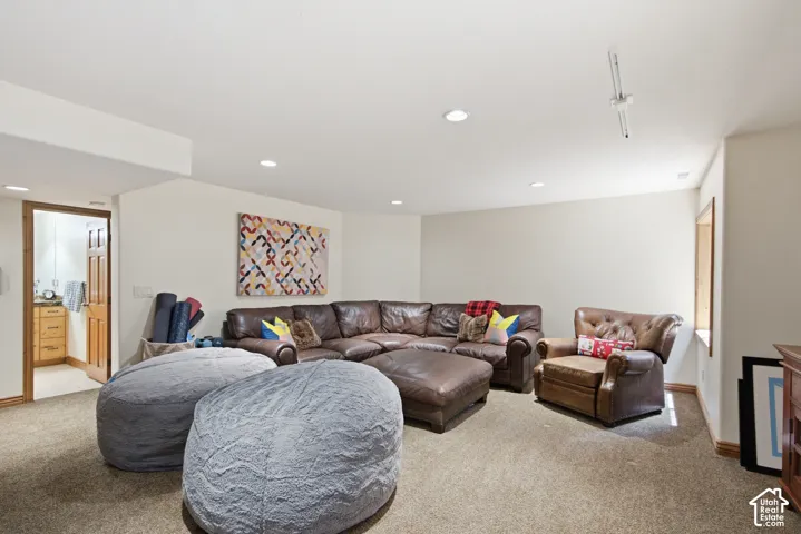 Carpeted room featuring recessed lighting and a window with wood trim