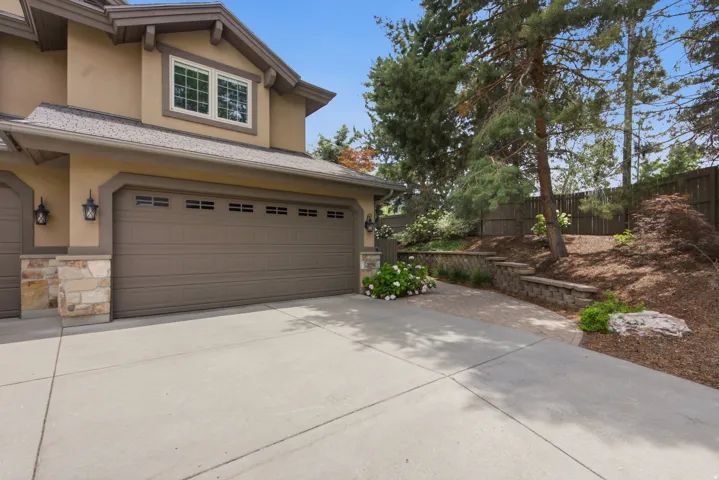 Attached two-car garage with panel detailing and transom windows