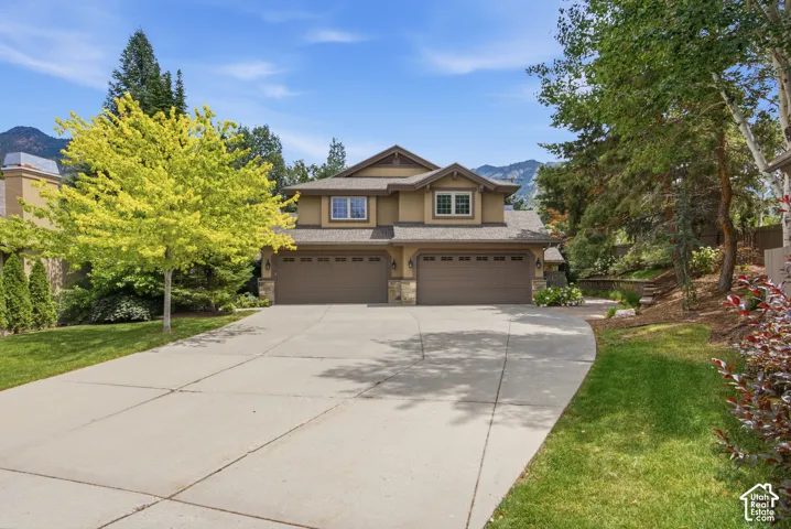 Stucco exterior with stone accents and a multi-car garage