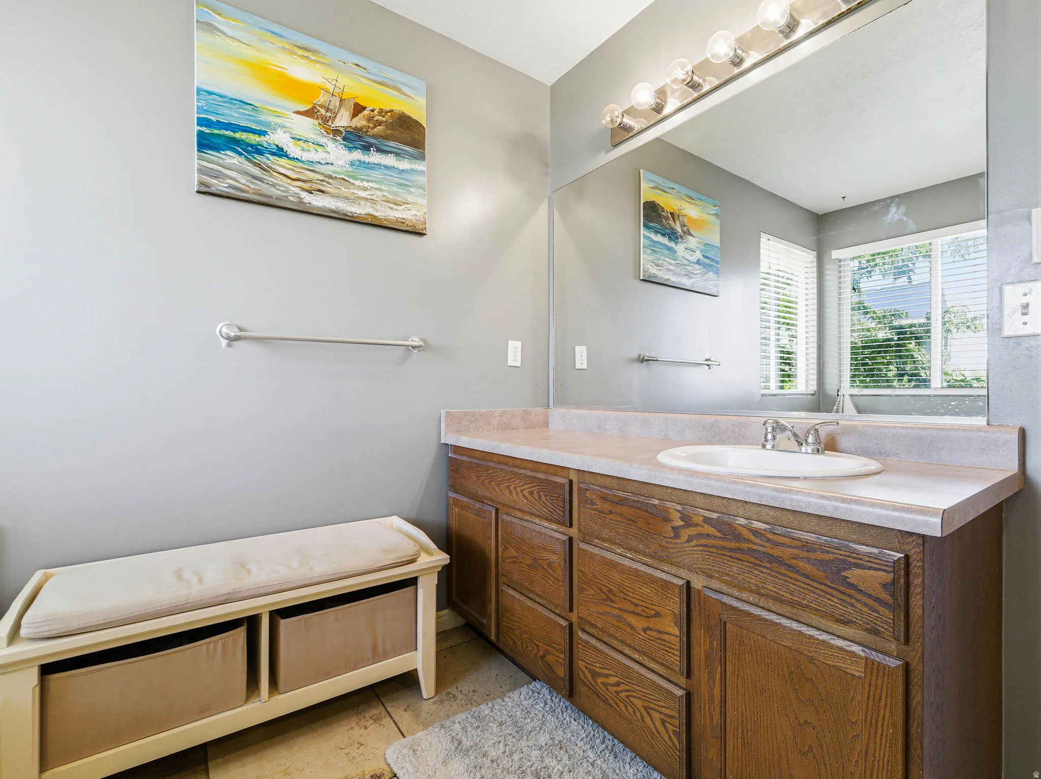 Wood-finish vanity with integrated sink and chrome faucet