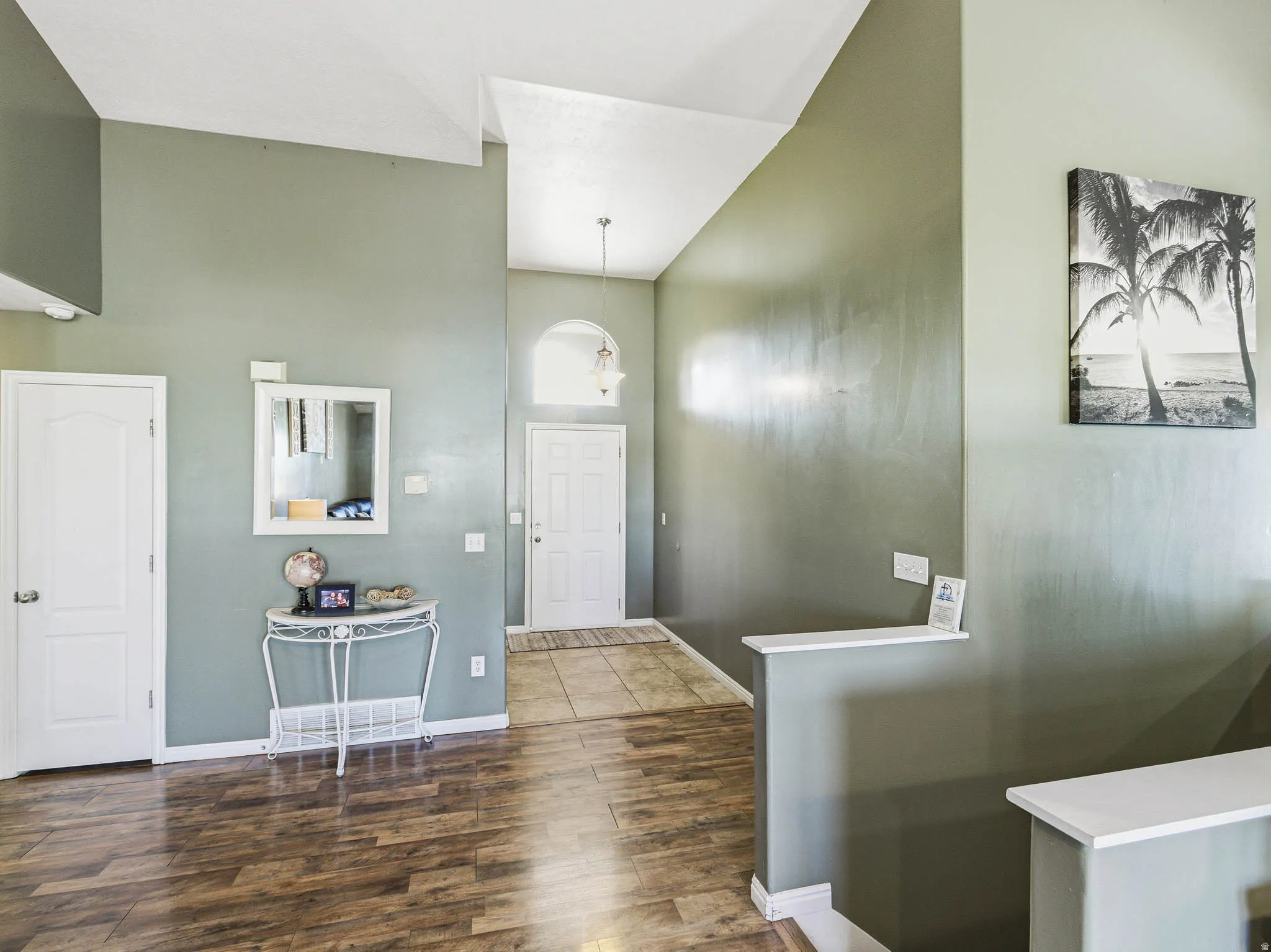 Vaulted ceiling entry with wood-finish flooring