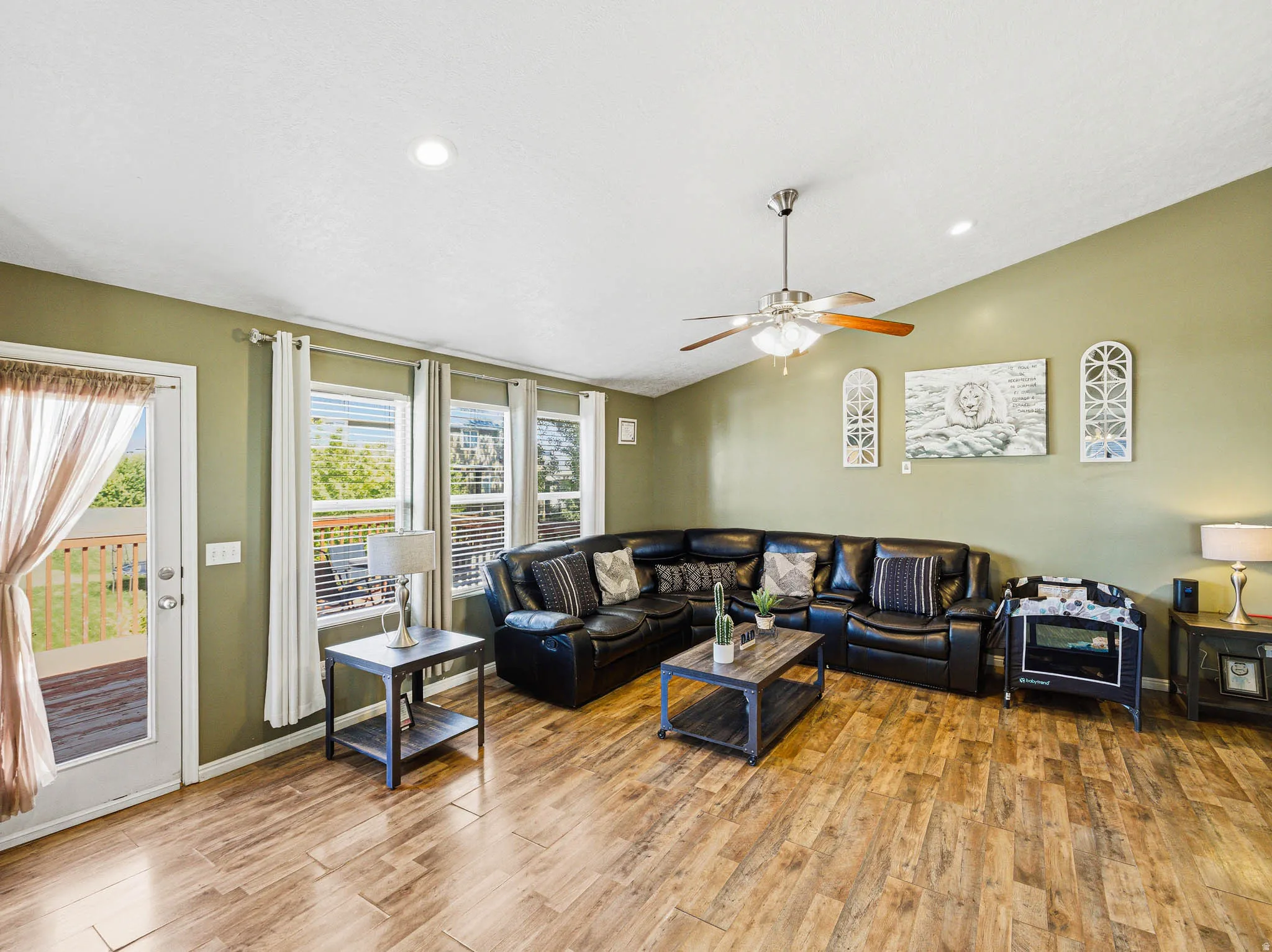 Spacious living area featuring wood-finish flooring, recessed lighting, and a ceiling fan