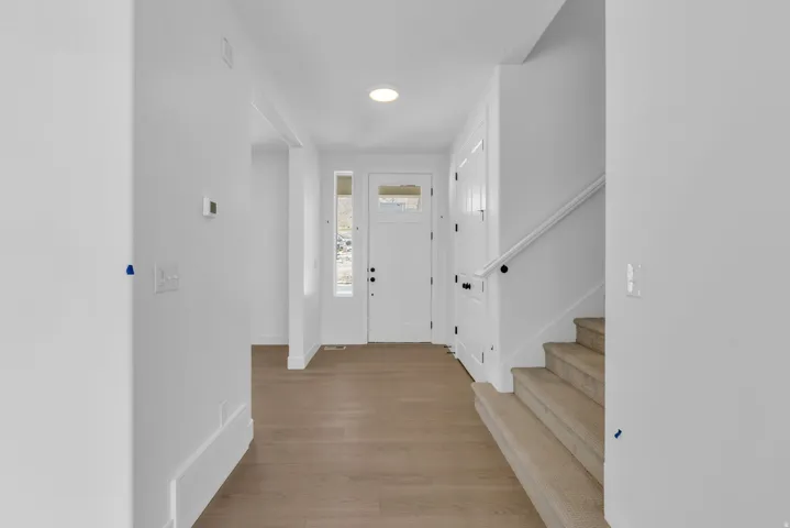 Spacious entryway with 8 foot tall front door, transom window and sidelight.