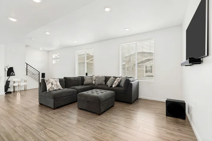Open-concept living space with wood-finish flooring