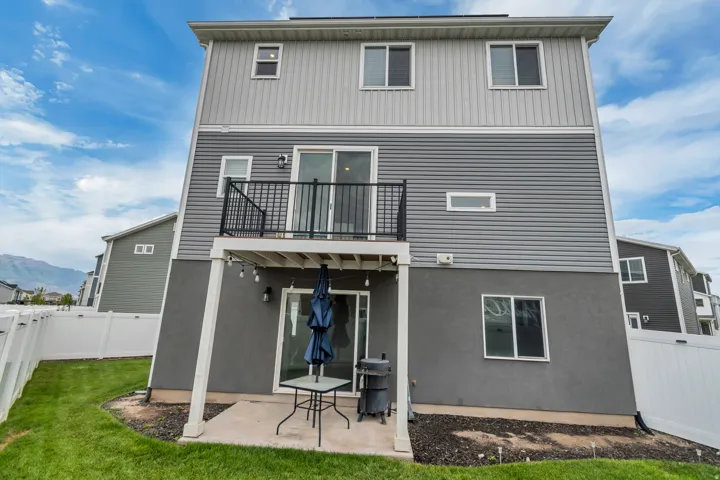 Rear exterior featuring a multi-level design with light and dark gray siding and stucco