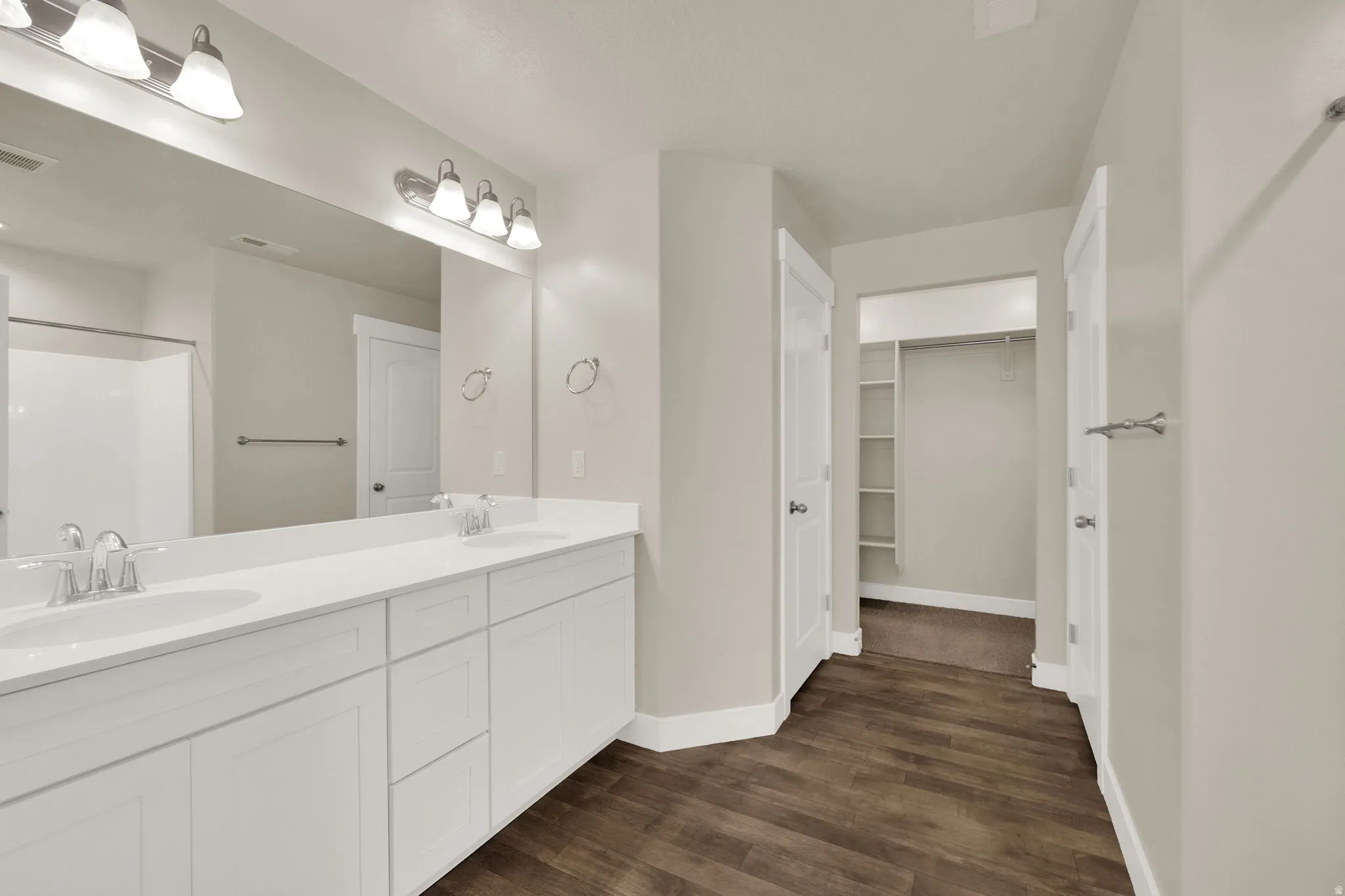 Double vanity with white cabinetry and integrated sinks