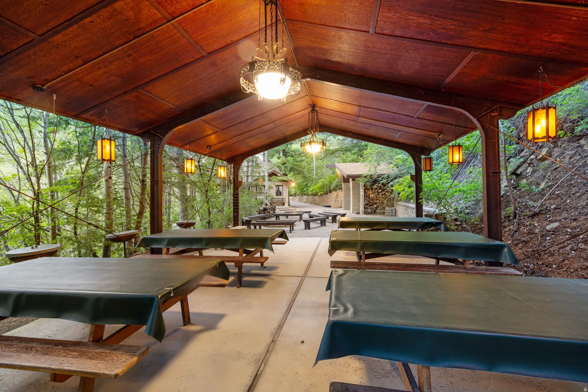 Covered patio featuring a wood-paneled ceiling and decorative pendant lighting