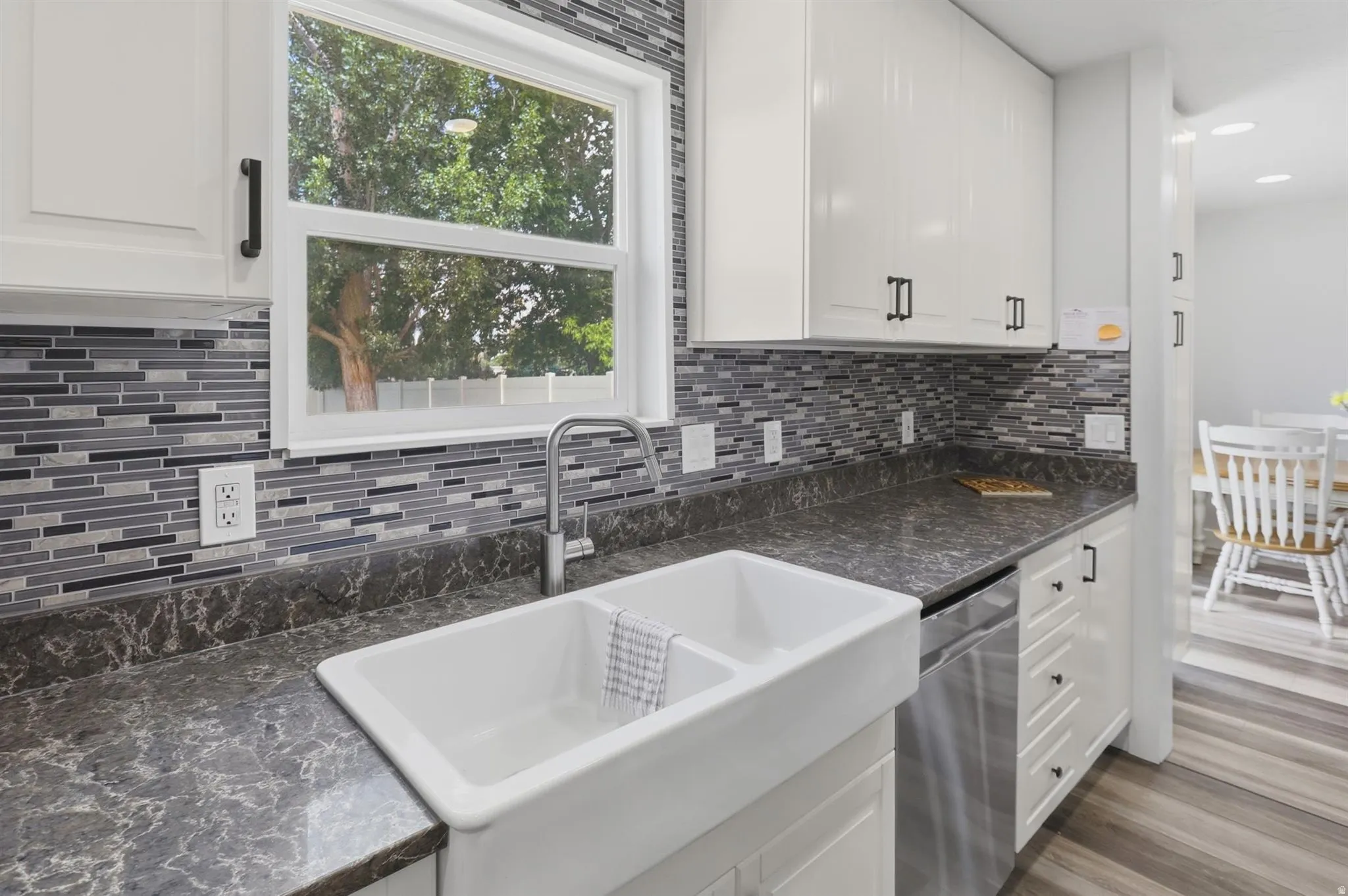 Dual-basin farmhouse sink with a gooseneck faucet