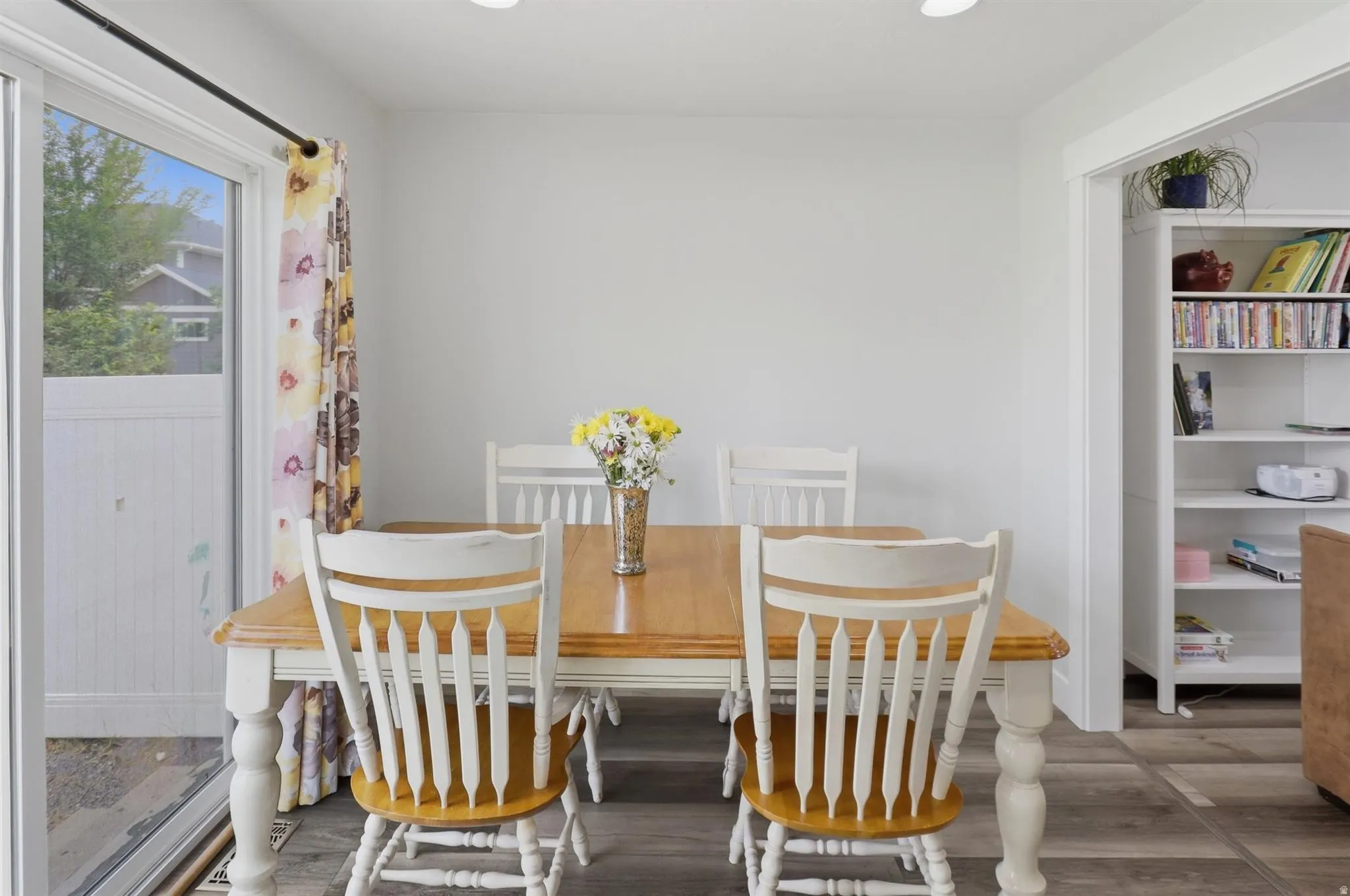 Dining area with wood-finish flooring and recessed lighting