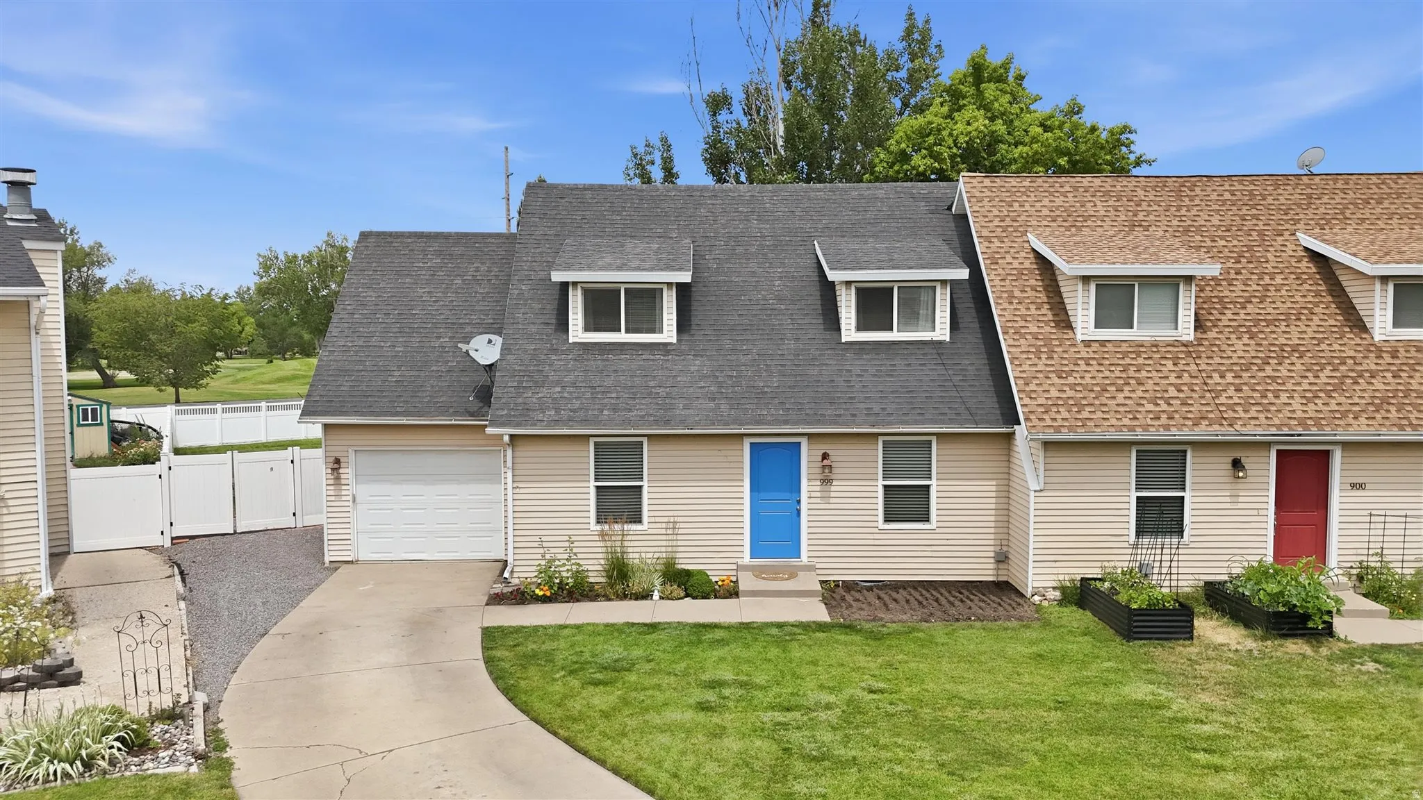Cream-colored siding exterior with a dark shingle roof and two dormer windows