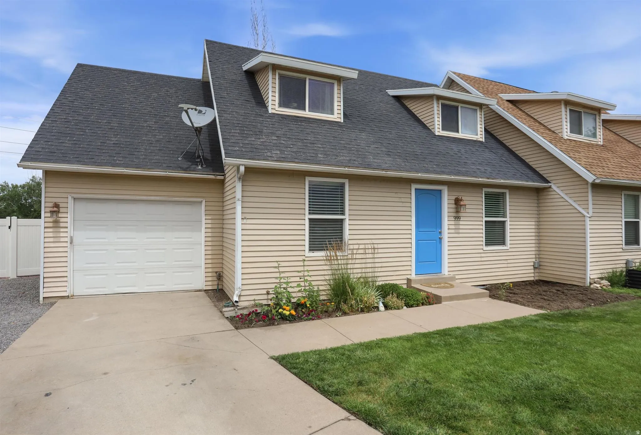 Exterior featuring light beige siding, a dark shingle roof, a single-car garage, and a vibrant blue entry door