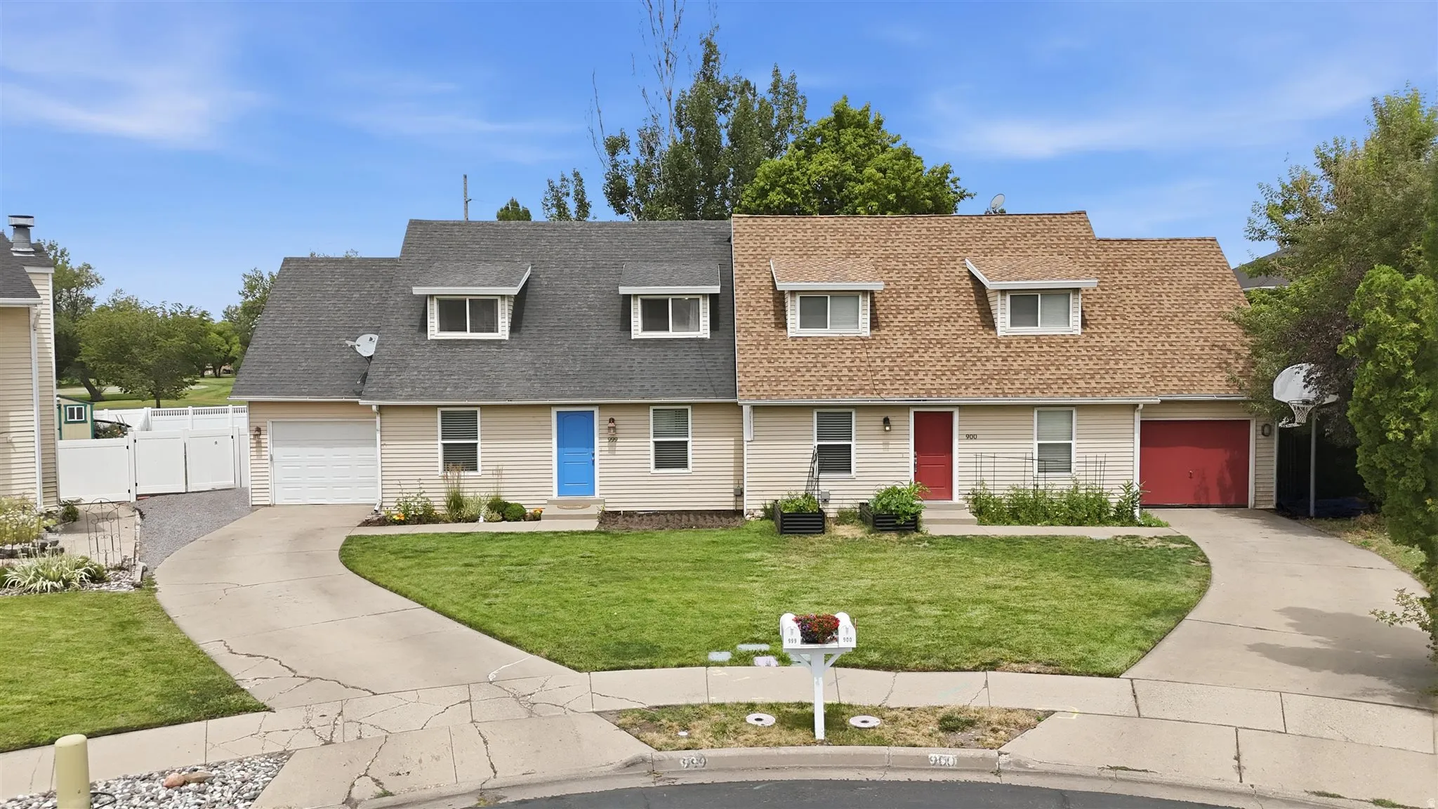 Twin properties, featuring two distinct units, each with individual driveways and attached garages