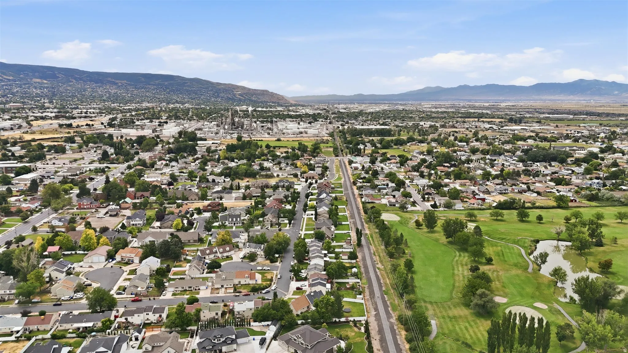 Aerial perspective showcasing trail running between a residential area and golf course.
