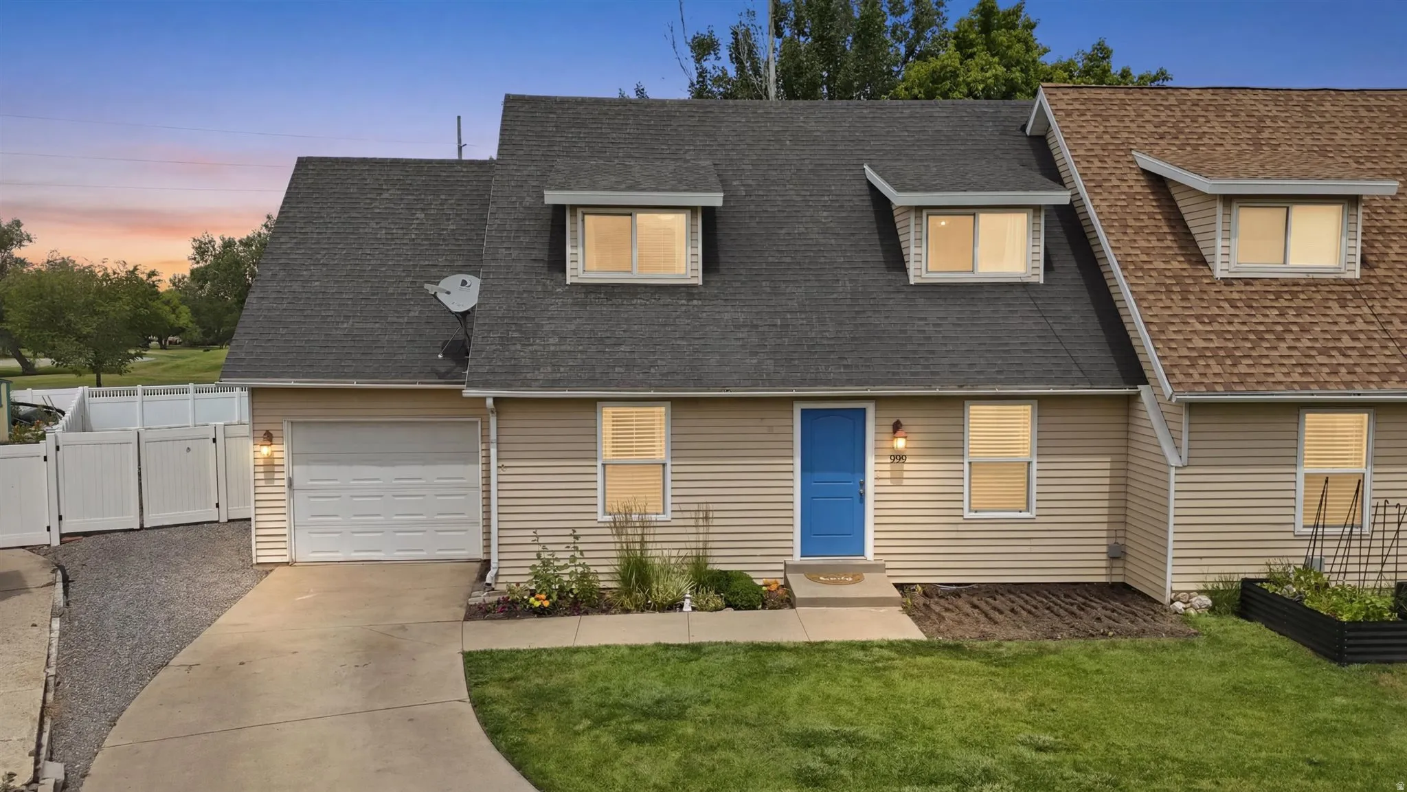 Cream-colored siding exterior featuring a prominent blue entry door