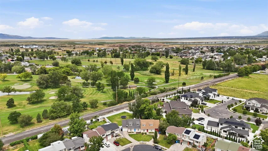 Expansive aerial overview showcasing a residential community bordering a golf course