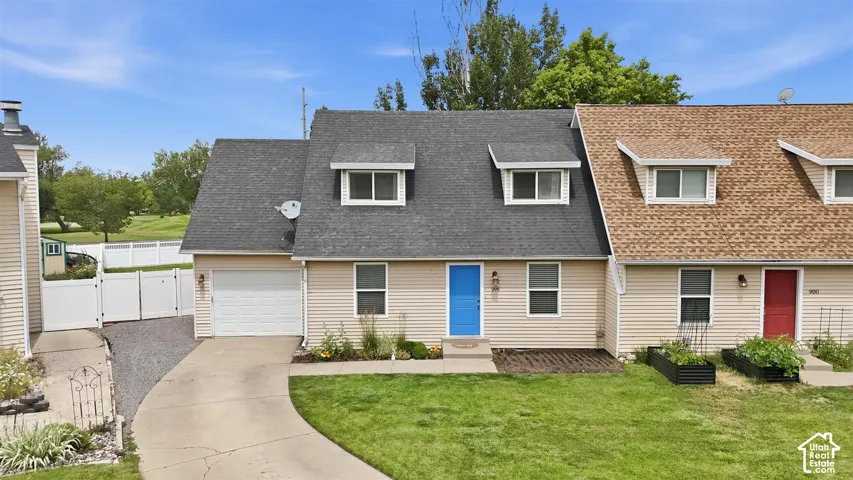 Cream-colored siding exterior with a dark shingle roof and two dormer windows