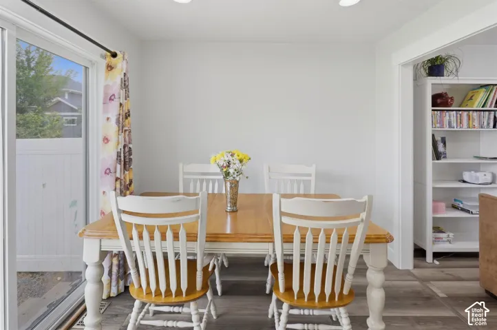 Dining area with wood-finish flooring and recessed lighting