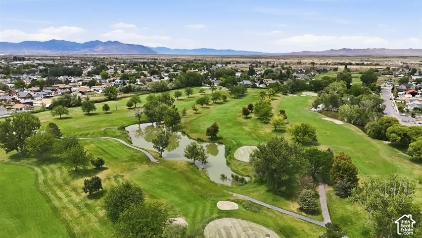 Expansive golf course featuring multiple greens, sand traps, and water features