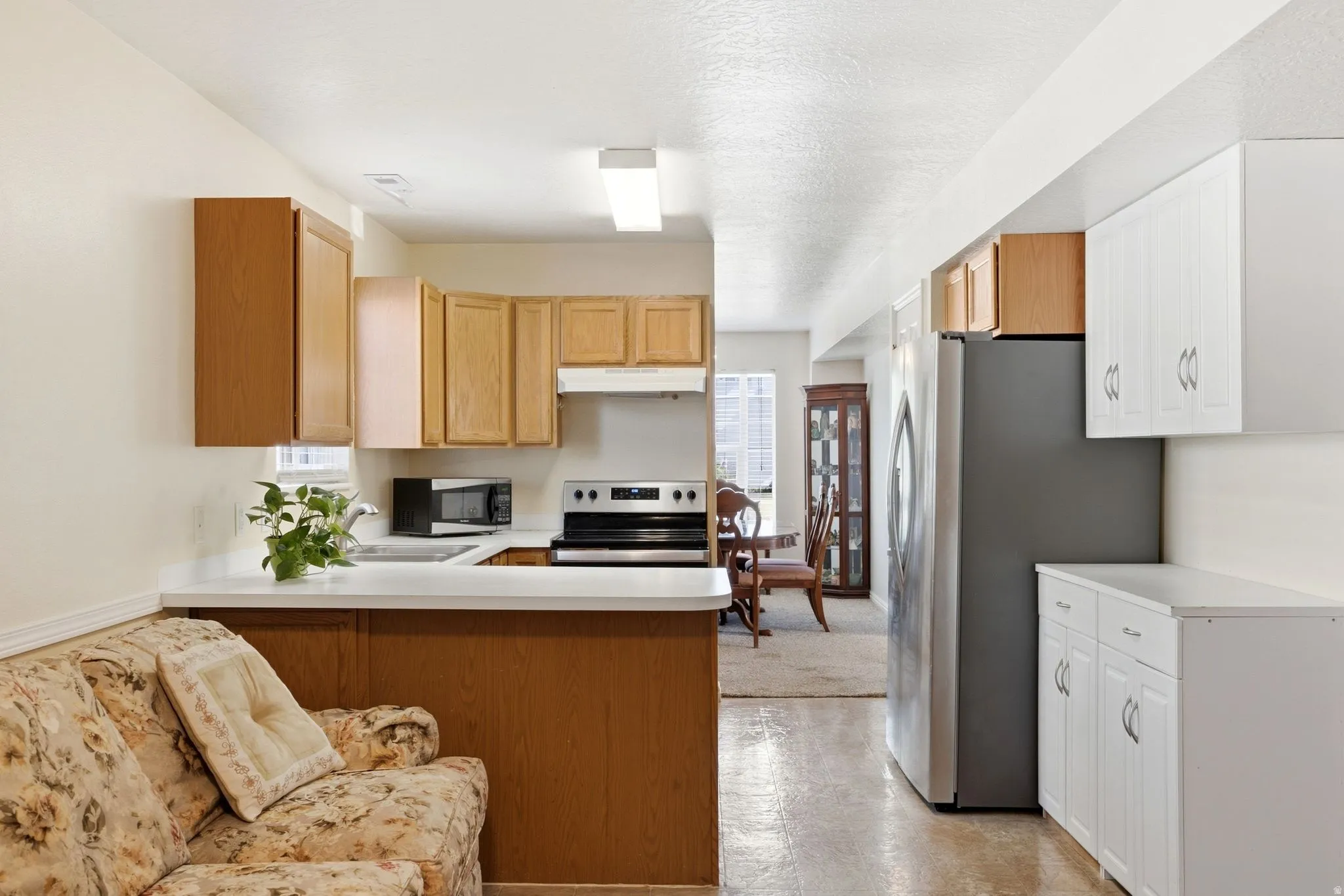 Kitchen featuring a full suite of appliances, wood-finish cabinetry, white countertops, and recessed lighting