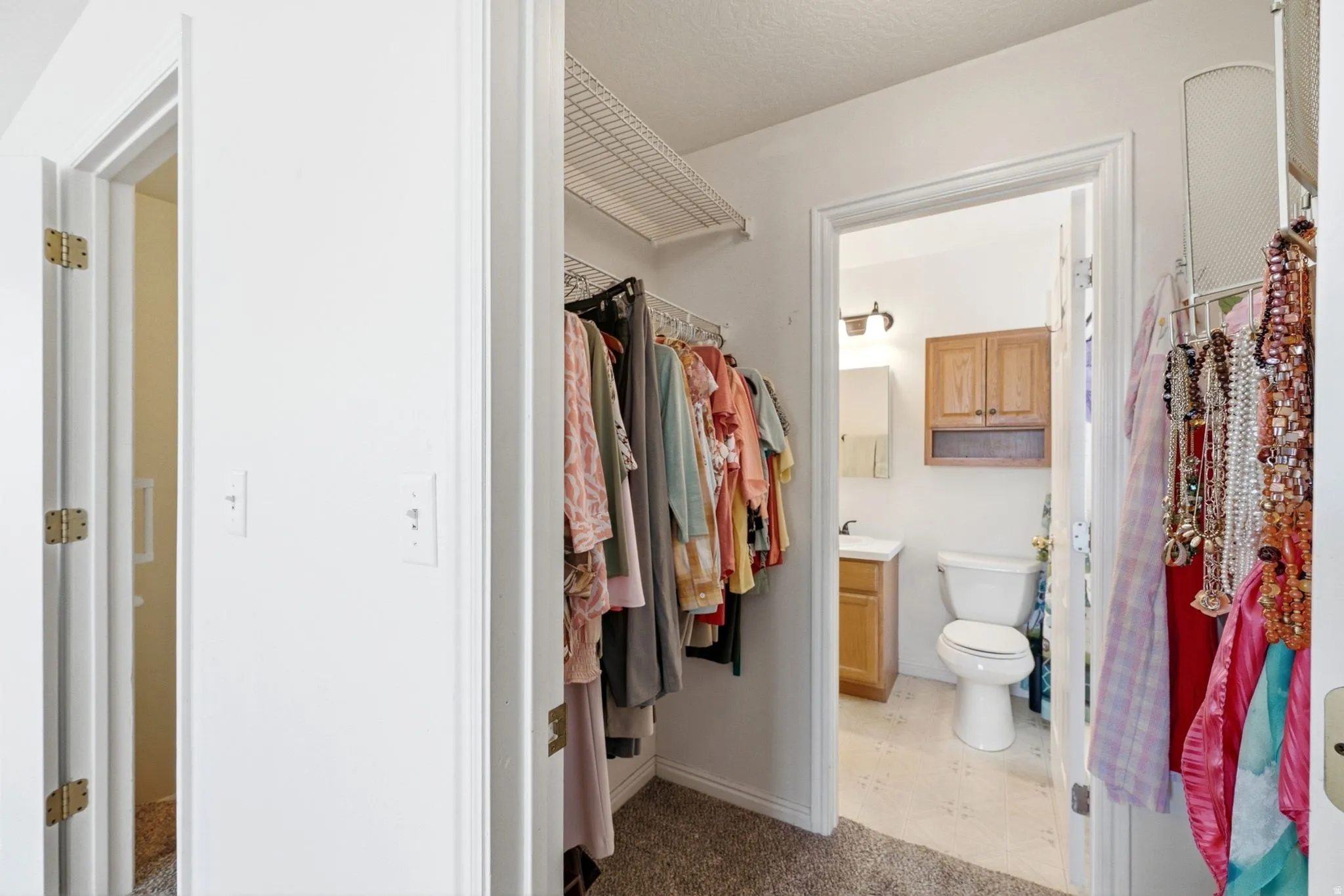 Walk-in closet with wire shelving and hanging rods