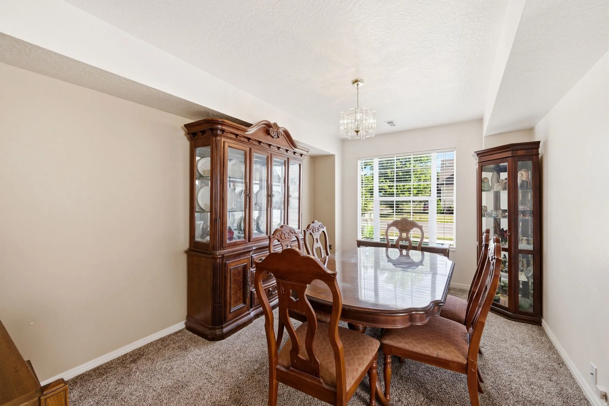 Dining area with neutral wall tones and textured carpeting