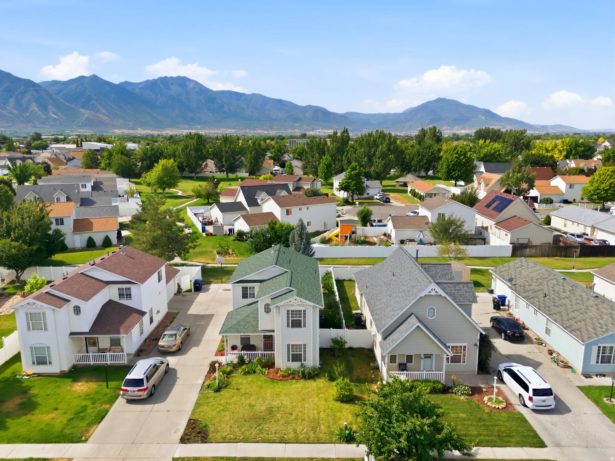 Suburban neighborhood featuring a mountain backdrop and mature trees