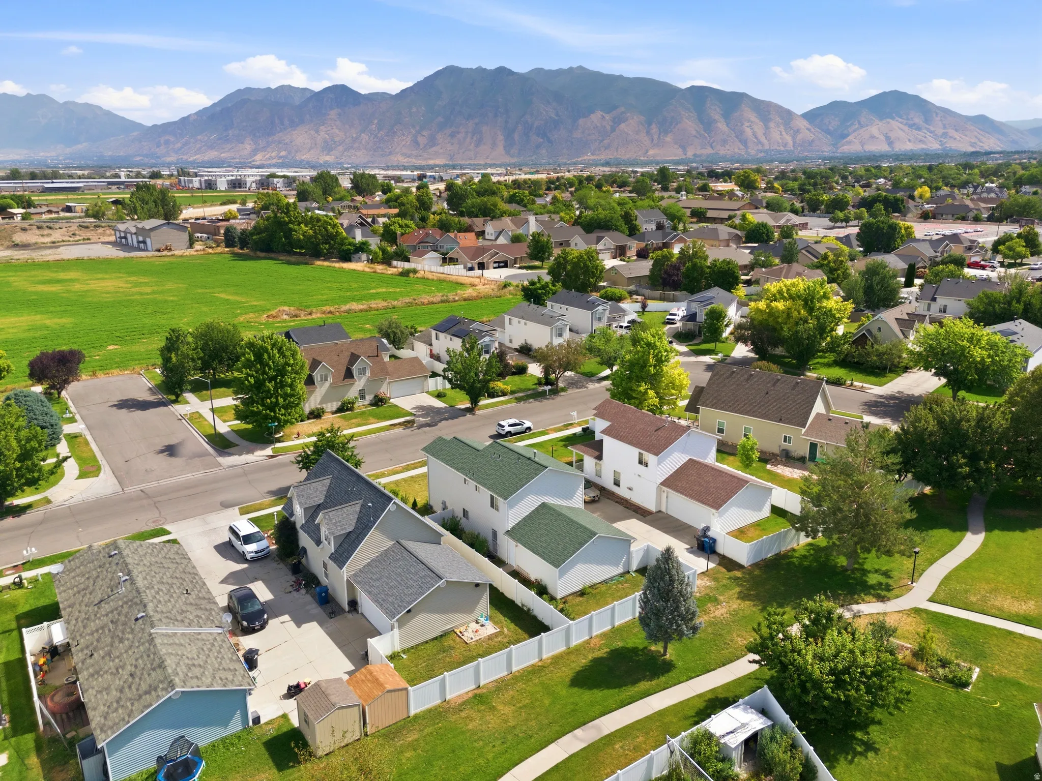 Aerial perspective highlighting a residential community with distant mountain ranges