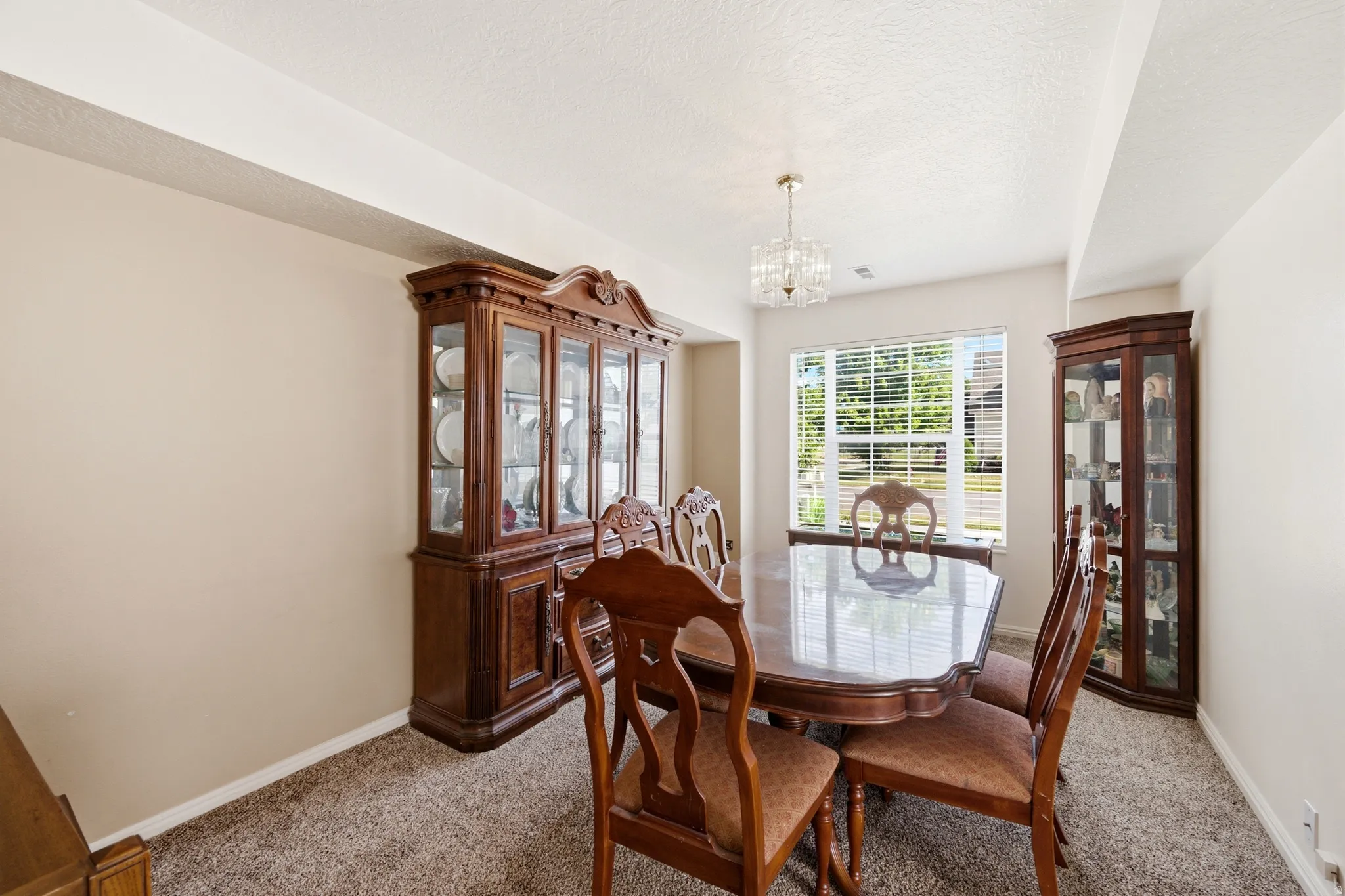 Spacious room featuring neutral-toned walls and plush carpeting