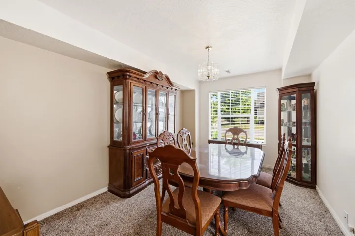 Dining area with neutral wall tones and textured carpeting