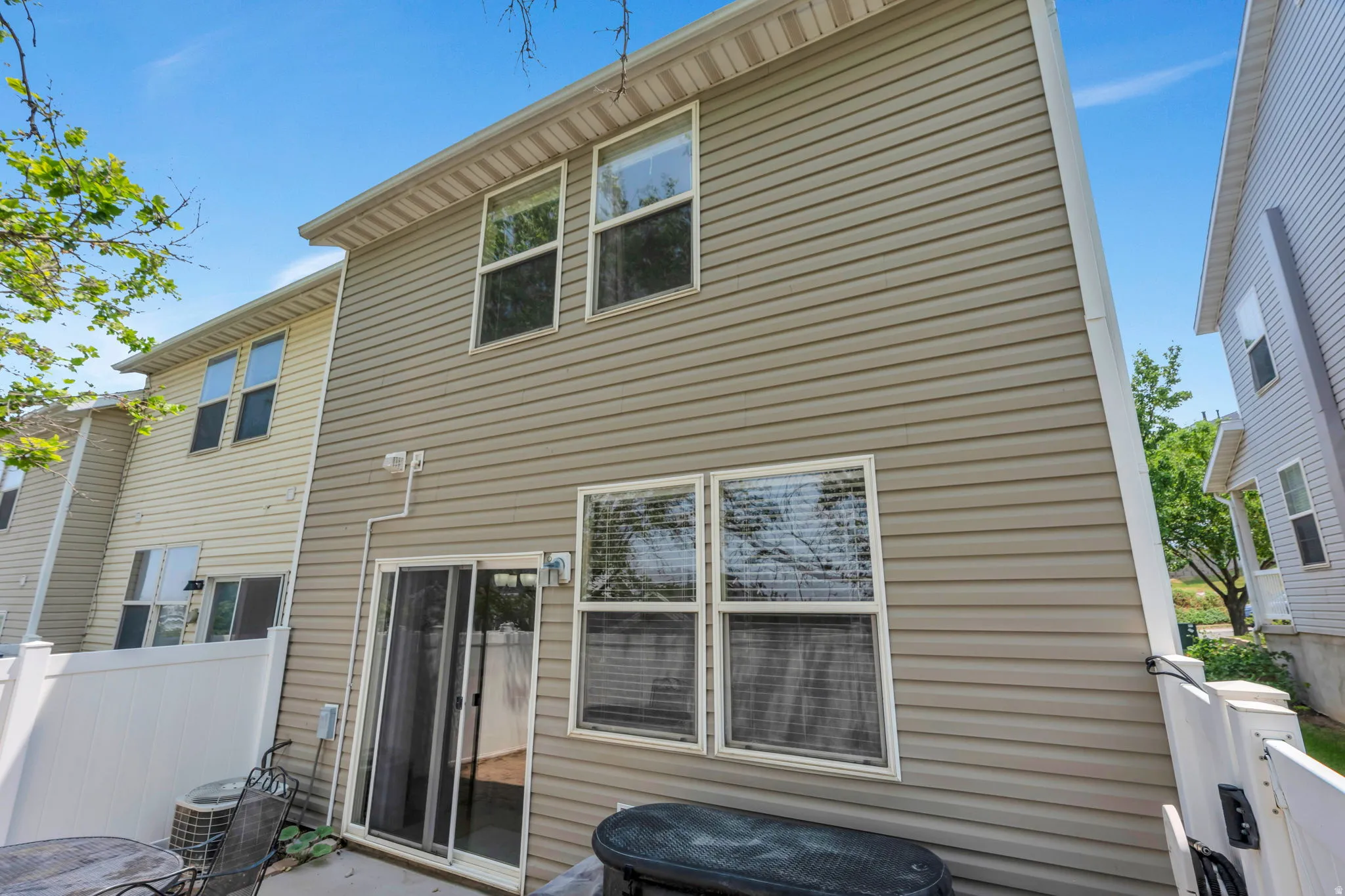 Rear exterior featuring tan horizontal siding