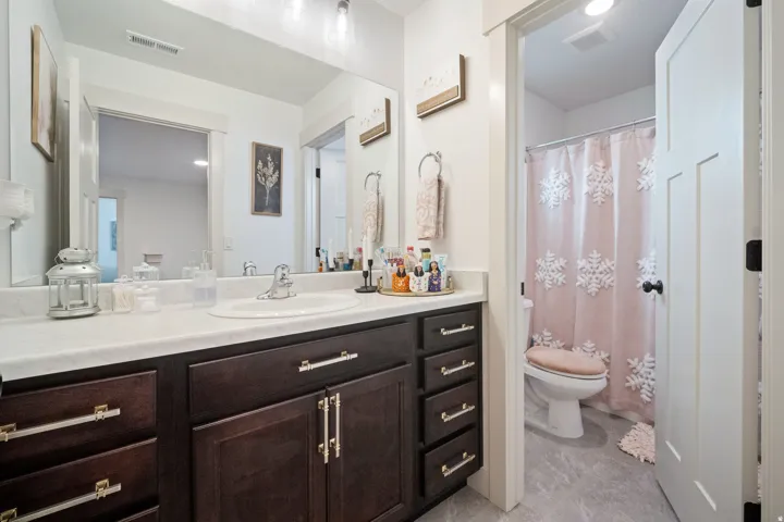 Dark wood-finish vanity with ample storage and silver-tone hardware