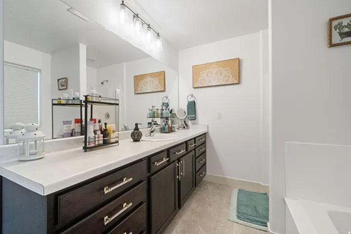 Double vanity with dark wood-finish cabinetry and brushed nickel hardware