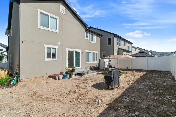 Rear exterior of a residence featuring neutral stucco siding